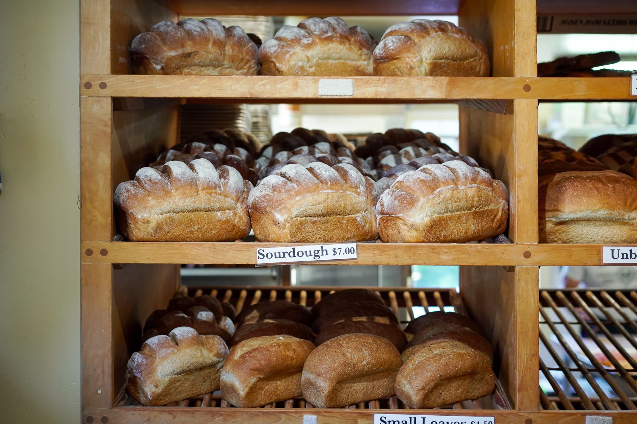 Fresh bread on wooden shelves at Ottavio Italian Bakery